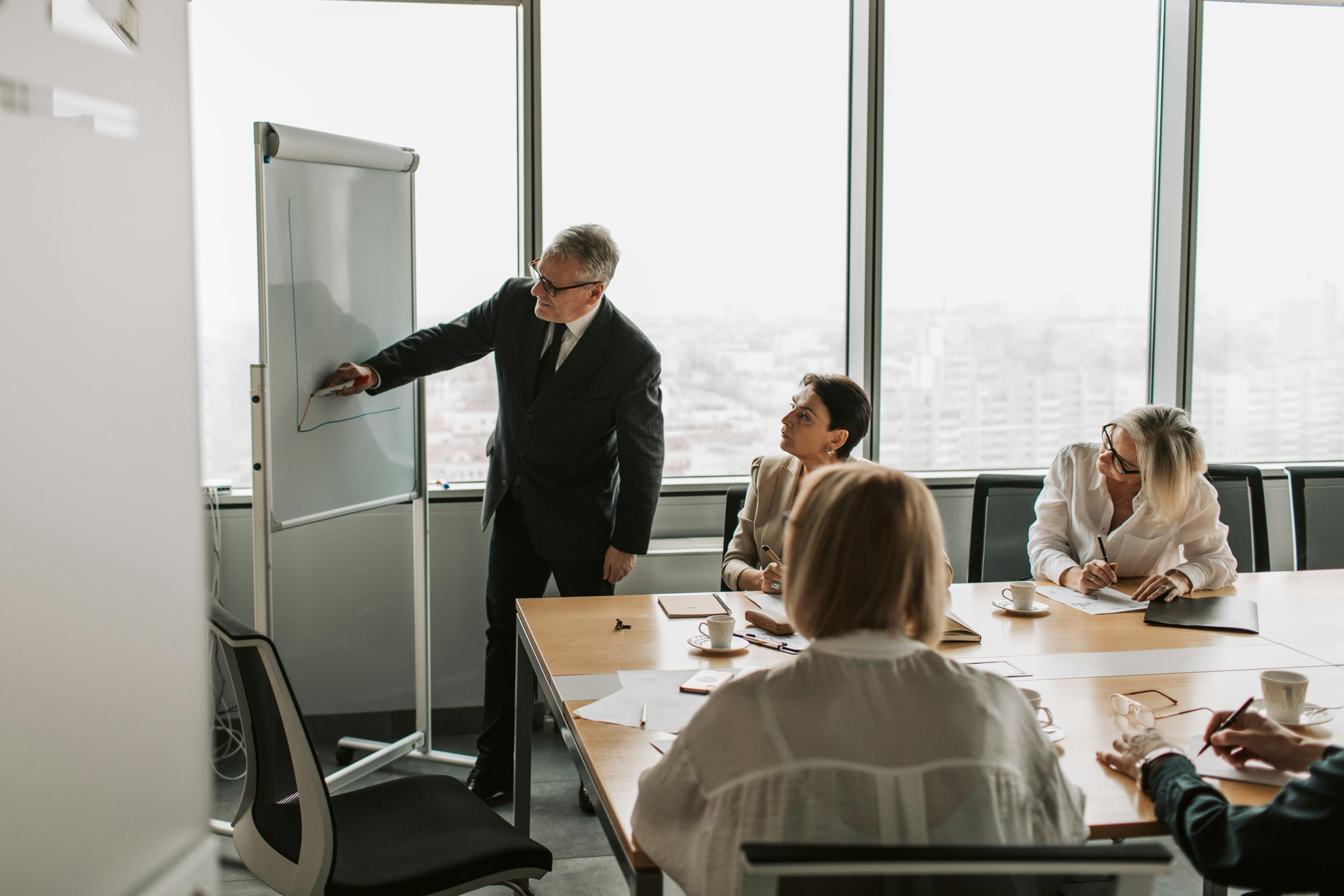 Senior leadership meeting in a polished office setting.